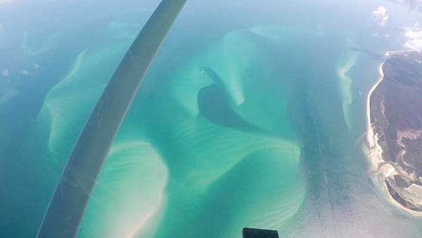 Skydiving over crystal clear waters